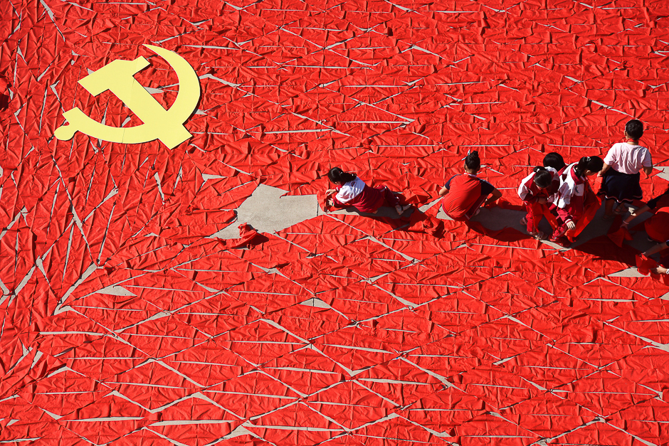 Students use red scarves to make a flag of the Communist Party of China, ahead of the 19th National Congress of the Communist Party, at a primary school in Linyi, Shandong province, China. PHOTO: REUTERS