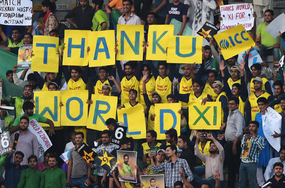 Spectators hold a sign during the final match of World XI cricket series. PHOTO: REUTERS