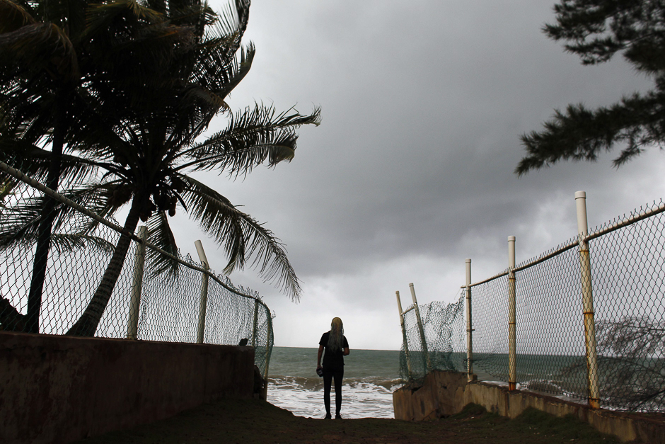 A woman looks at heavy surf as Hurricane Irma approaches Puerto Rico in Luquillo. PHOTO: AFP