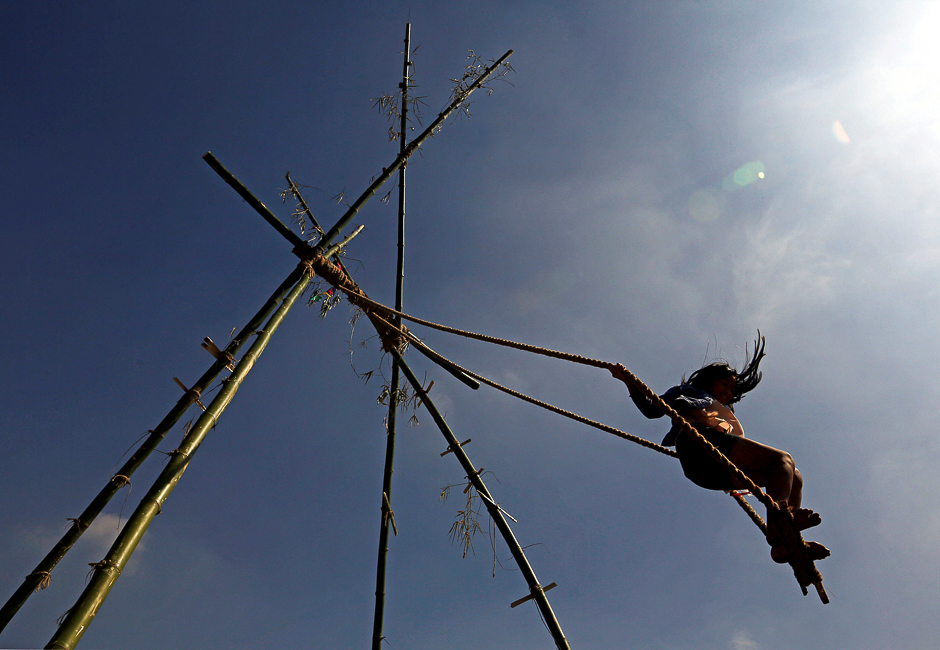 A girl plays on a traditional swing during Dashain, the biggest religious festival for Hindus in Nepal, in Kathmandu, Nepal. PHOTO: REUTERS