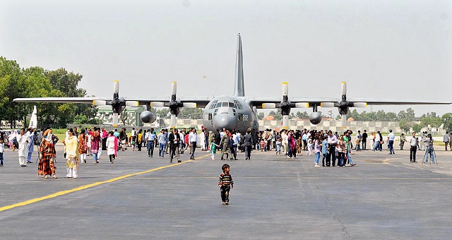 A number of people keenly watching aircraft and weapons displayed at Nur Khan Air Base. PHOTO: APP