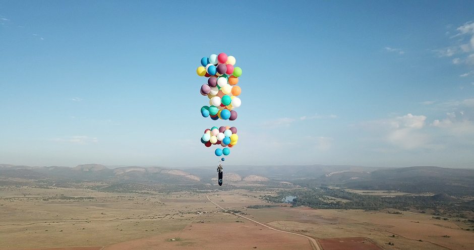 Tom Morgan, from Bristol-based company The Adventurists, flies in a chair with large party balloons tied to it near Johannesburg, South Africa. PHOTO: REUTERS