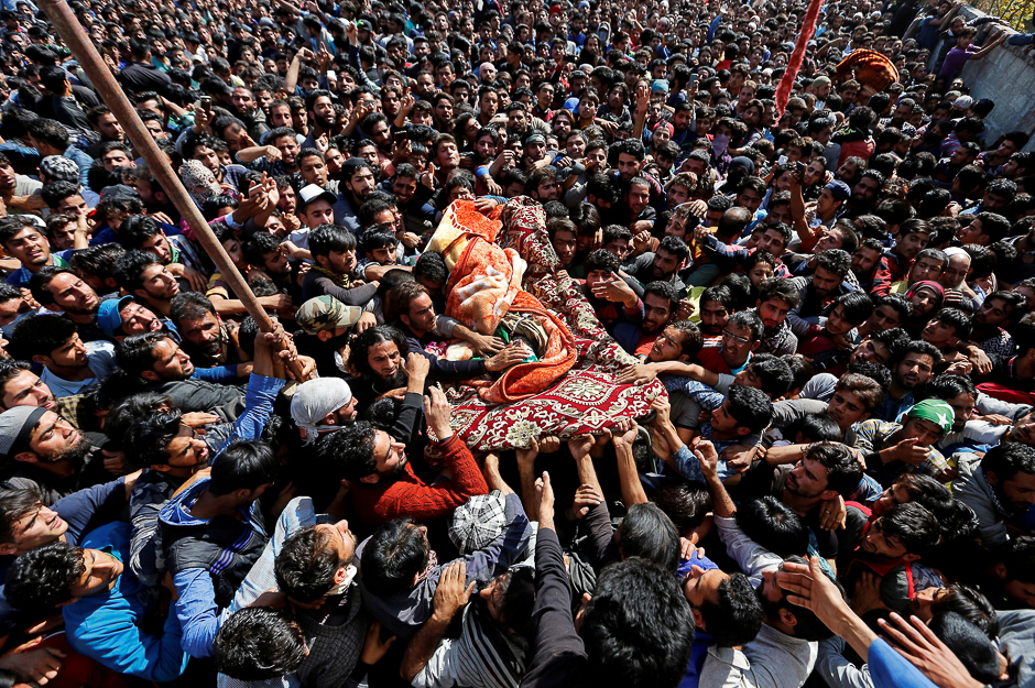 People carry the remains of Waseem Shah, a suspected militant commander, who according to the local media was killed during a gunbattle with Indian security forces in Pulwama district, during his funeral in Heff village in Shopian district. PHOTO: REUTERS