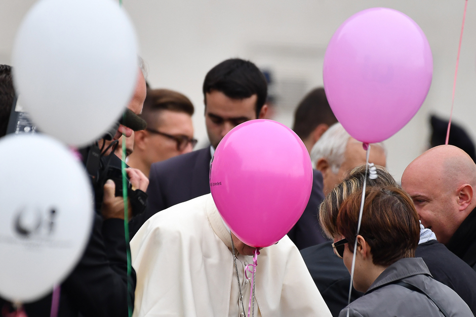 A pink balloon hides the face of Pope Francis during a weekly general audience at St Peter's square in Vatican. PHOTO: AFP