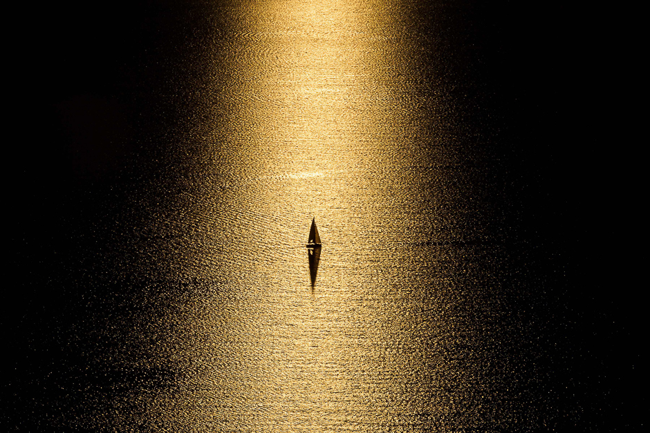 A boat is seen at sunset on Lake Geneva from Chexbres, western Switzerland. PHOTO: AFP