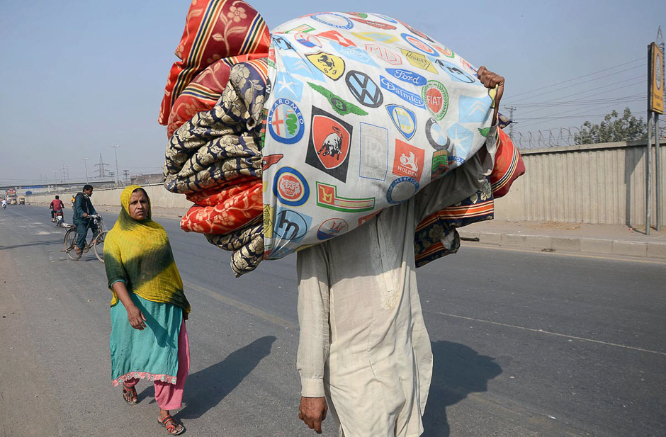 A man carrying quilts on his head at Bund road area, Lahore, Pakistan. PHOTO: ONLINE