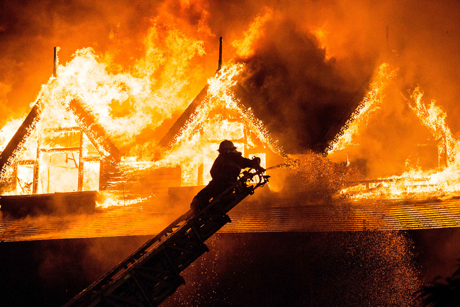 A firefighter extinguishes a fire at Kandawgyi Palace hotel in Yangon. PHOTO: AFP