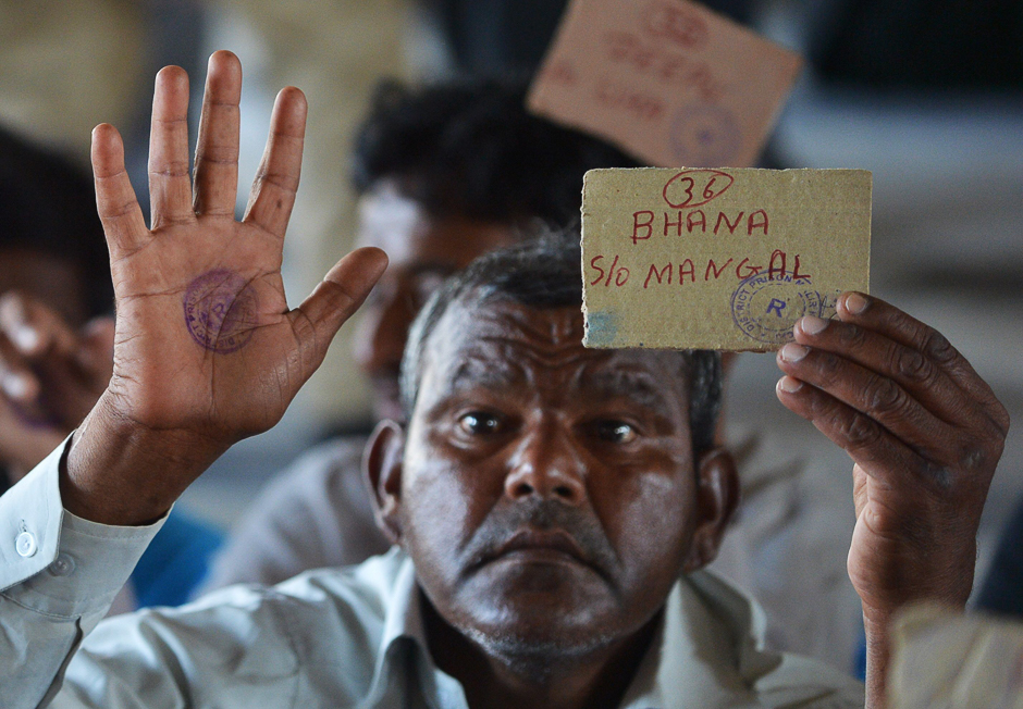 Indian fisherman released from Malir jail shows his travelling card at a railway station in Karachi. PHOTO: AFP