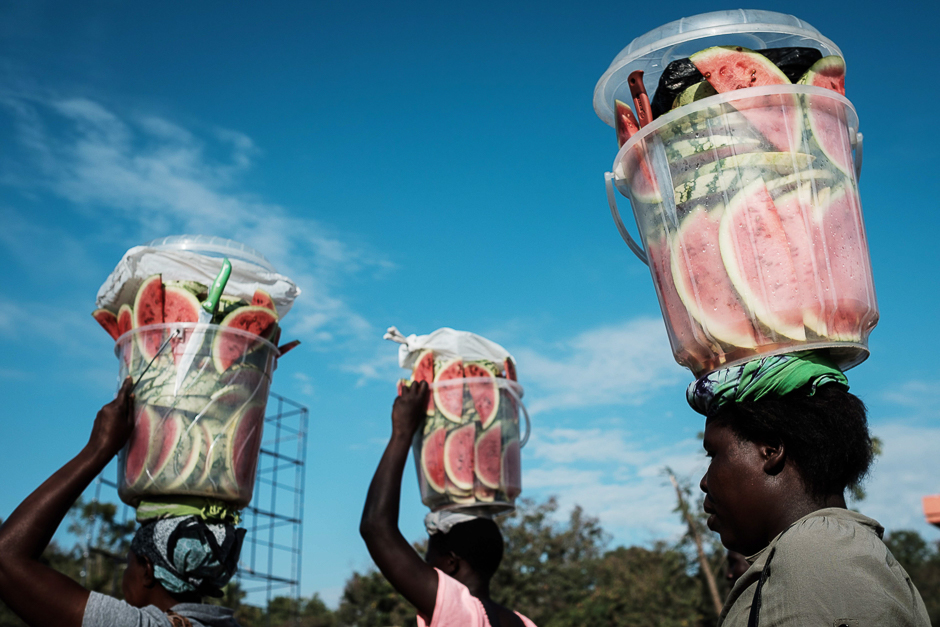 Women carry sliced water-melons in plastic containers on their head to sell at a market in Kisumu. PHOTO: AFP