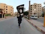 a-member-loyal-to-the-islamic-state-in-iraq-and-the-levant-isil-waves-an-isil-flag-in-raqqa-2-2-2-2-2-2-3-2-2-2-2-2-2-2-2-3-2
