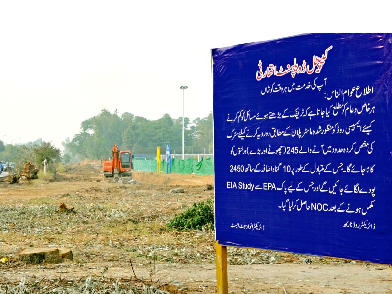 a cda signboard in urdu reads that the authority has fulfilled formalities to fell trees on embassy road photo zafar aslam express