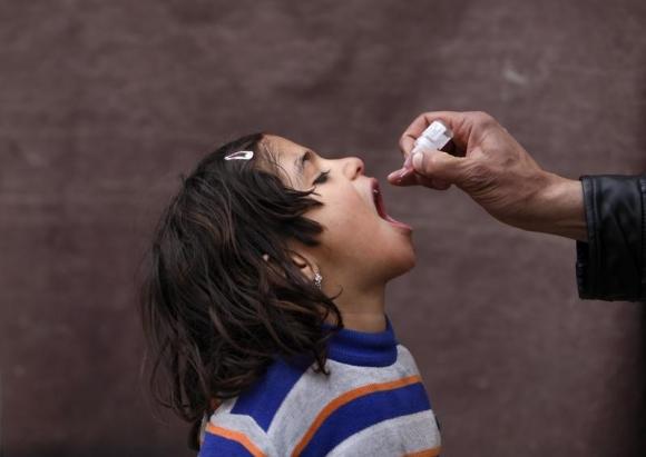 child receives polio vaccination drops photo reuters
