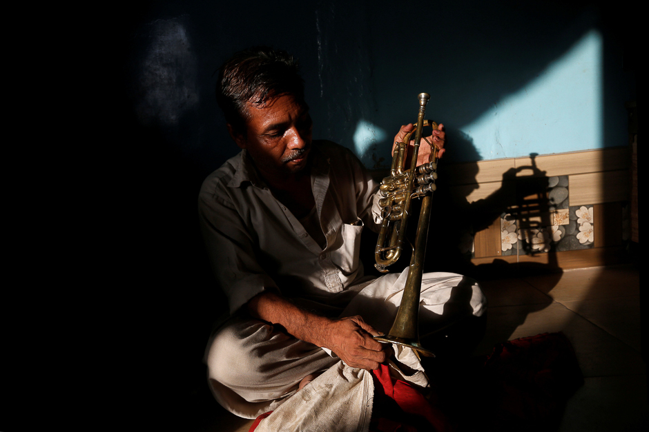 Waheed Ahmed, a 40 year-old musician, practices playing trumpet with which he performs with a local band during wedding ceremonies in Karachi, Pakistan. PHOTO: REUTERS