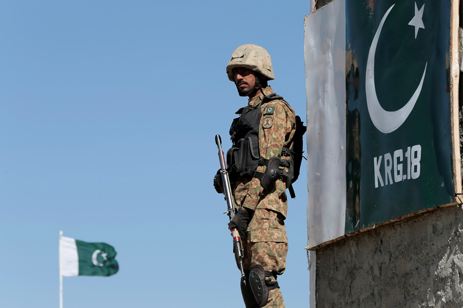 A soldier stands guard at the Angoor Adda outpost along the border fence on the border with Afghanistan in South Waziristan, Pakistan. PHOTO: REUTERS