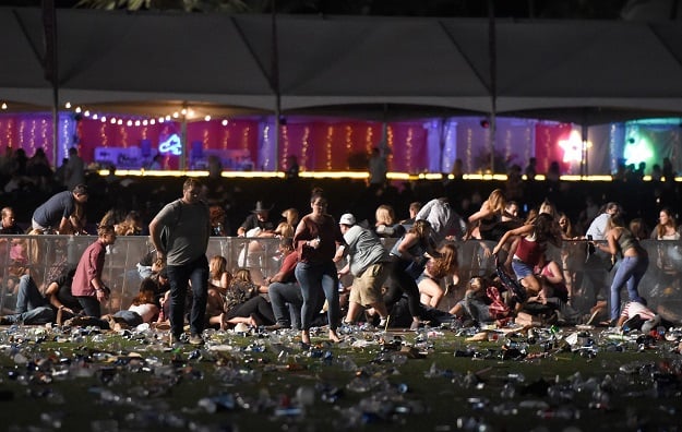 People run from the Route 91 Harvest country music festival after apparent gun fire was heard on October 1, 2017 in Las Vegas, Nevada. PHOTO: AFP