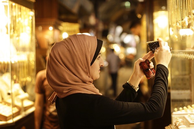 Palestinian Kholoud Nassar, 26, uses her mobile phone to take pictures for her social media account in Deir al-Balah in the central Gaza strip. PHOTO: AFP
