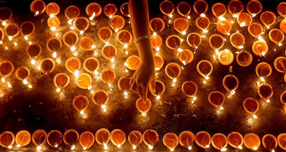 A devotee lights oil lamps at a religious ceremony during the Diwali or Deepavali festival at a Hindu temple in Colombo, Sri Lanka. PHOTO: REUTERS