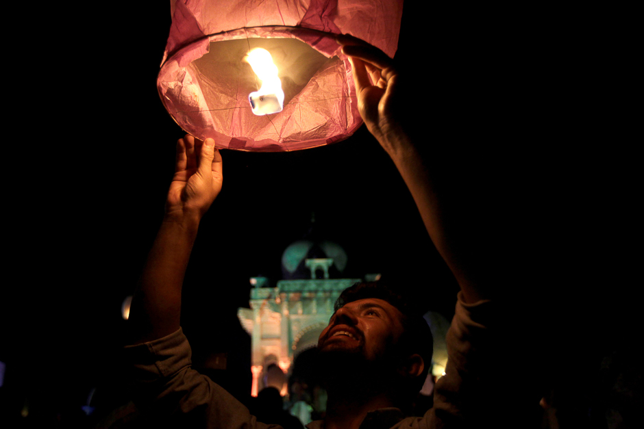 A man releases a lantern to mark the anniversary of the 2005 Kashmir earthquake, after a disaster awareness ceremony in Islamabad, Pakistan. PHOTO: REUTERS