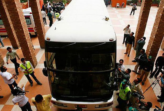 Members of the media gathered around the bus, which carried the Sri Lankan cricket team, parked outside the Gaddafi Stadium in Lahore. PHOTO: REUTERS 