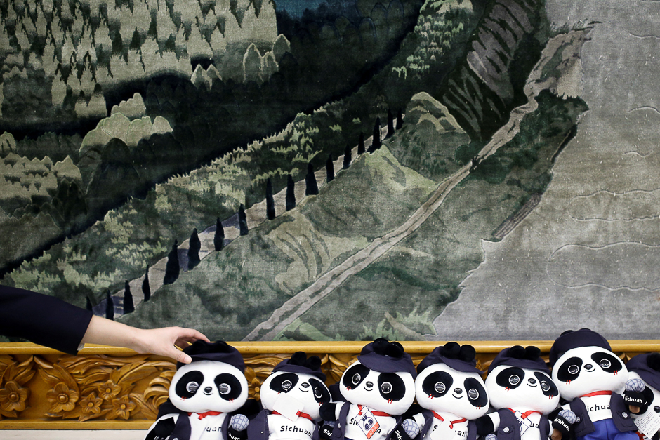 A man arranges Panda soft toys during a session of the Sichuan province on the second day of the 19th National Congress of the Communist Party of China at the Great Hall of the People in Beijing. PHOTO: REUTERS