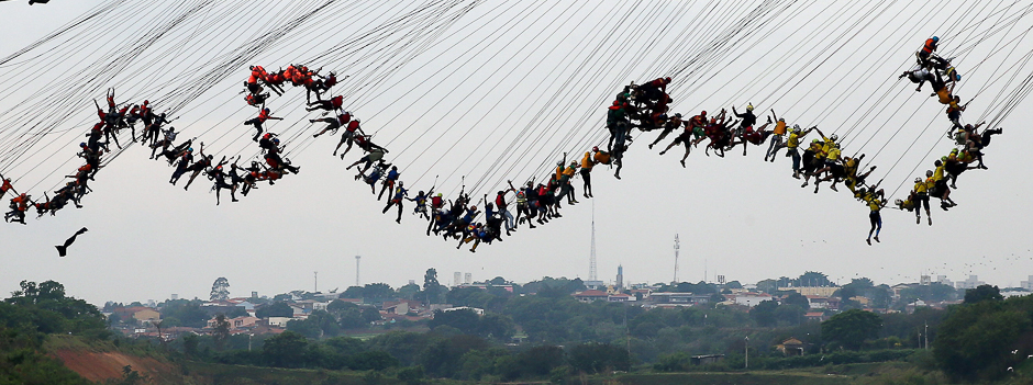 People jump off a bridge, which has a height of 30 metres, in Hortolandia, Brazil. According to organisers, 245 people were attempting set a new world record for 