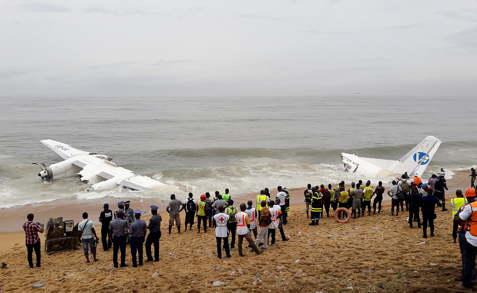 Policemen and rescuers stand near the wreckage of a cargo plane after it crashed in the sea near the international airport in Ivory Coast's main city, Abidjan. PHOTO: REUTERS