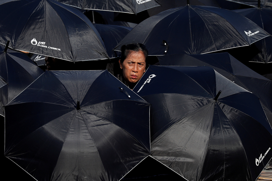 Mourners shield themselves from the sun as they wait for the Royal Cremation ceremony of Thailand's late King Bhumibol Adulyadej to begin near the Grand Palace in Bangkok, Thailand PHOTO: REUTERS