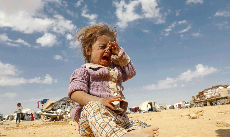 A girl cries at a refugee camp for people displaced in fighting between the Syrian Democratic Forces and Islamic State militants in Ain Issa, Syria. PHOTO: REUTERS