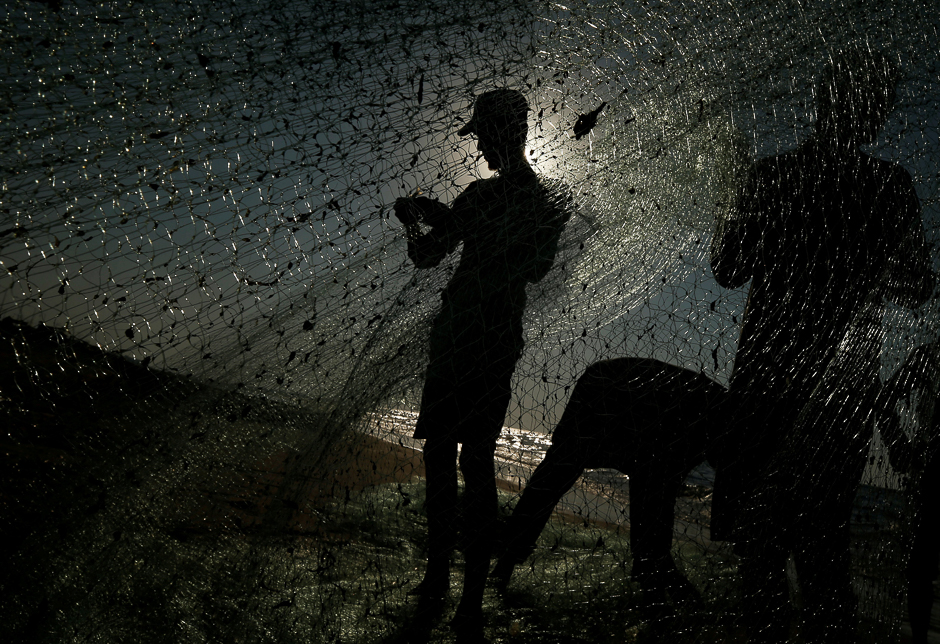 Palestinian fishermen repair their net at the beach in Gaza City. PHOTO: REUTERS