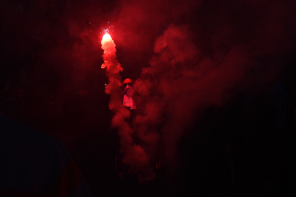 A Marseille supporter burns a flares a few hours prior to kick off of the French L1 football match between Marseille (OM) and Paris Saint-Germain (PSG), outside the Velodrome Stadium in Marseille, southeastern France. PHOTO: AFP