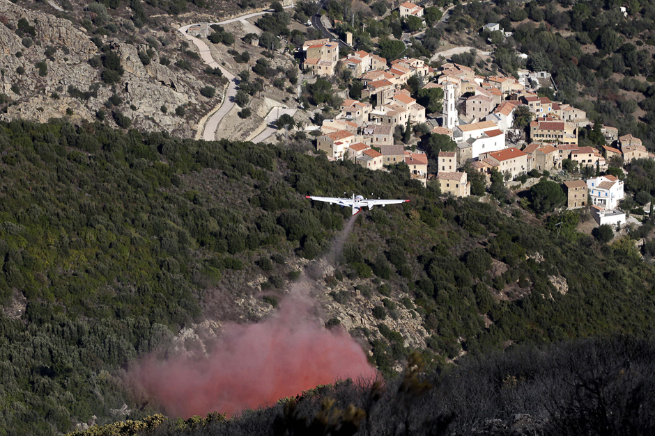 A Tracker firefighting plane drops flame retardant over a wildfire near Palasca, after a fire that devastated nearly 2,000 hectares of forest on the French Mediterranean Island of Corsica. PHOTO: AFP