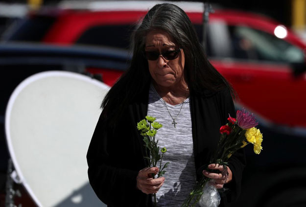 A woman leaves flowers at a makeshift memorial along Las Vegas Boulevard following a mass shooing in Las Vegas, Nevada, US. PHOTO: REUTERS