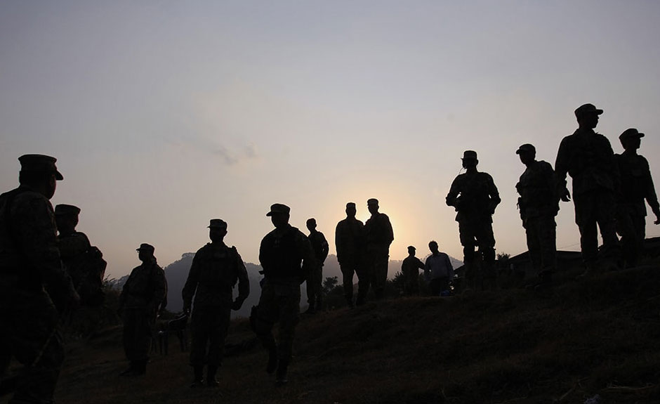 Pakistani soldiers gathered at a forward area post on the Line of Control. PHOTO: AP
