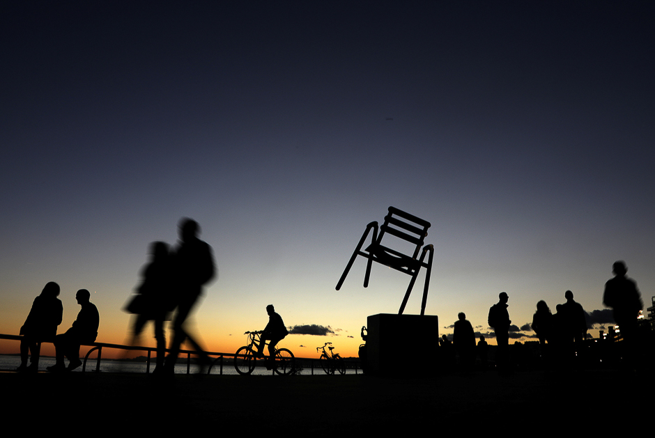 People walk at sunset on the Promenade des Anglais in Nice, France. PHOTO: REUTERS