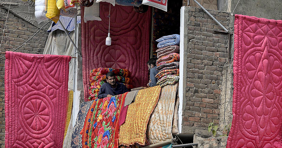 A vendor displays quilts to attract the customers as winter season approaches in Rawalpindi, Pakistan. PHOTO: APP