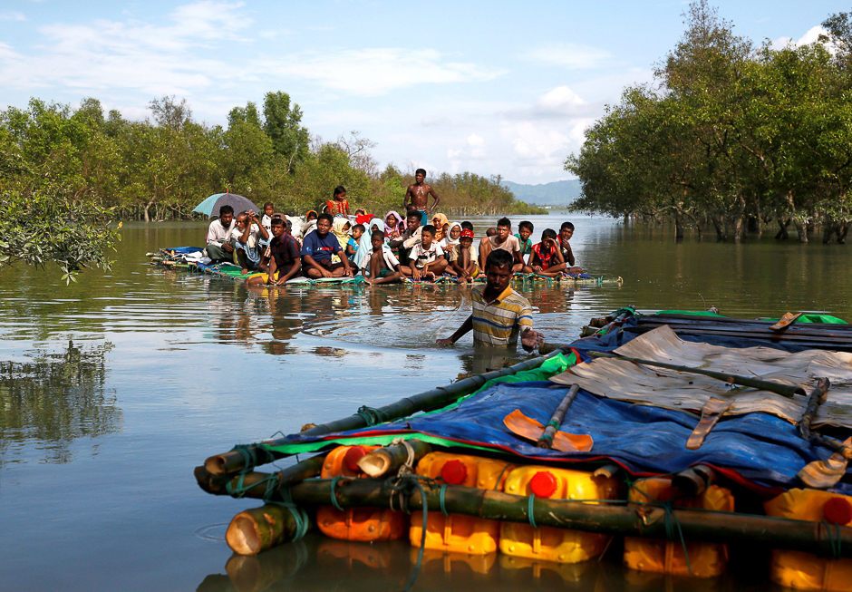 Rohingya refugees arrive on the banks of the Naf River on a makeshift raft after crossing the Bangladesh-Myanmar border, at Sabrang in Teknaf, near Cox's Bazar, Bangladesh. PHOTO: REUTERS