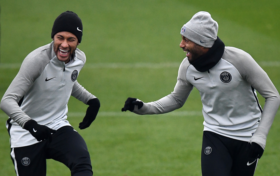 Paris Saint-Germain's Brazilian forward Neymar (L) jokes with Paris Saint-Germain's Brazilian forward Lucas as they take part in a training session in Saint-Germain-en-Laye, western Paris. PHOTO: AFP
