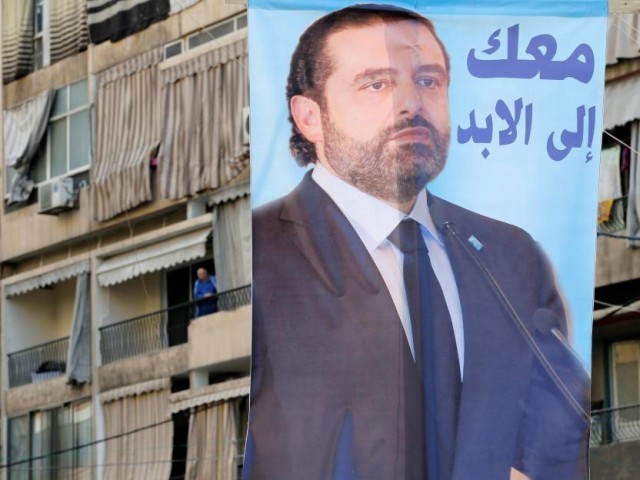 A poster depicting Lebanon's Prime Minister Saad al-Hariri, who has resigned from his post, hangs along a street in the mainly Sunni Beirut neighbourhood of Tariq al-Jadideh in Beirut, Lebanon November 6, 2017. The Arabic on the poster reads, "With you forever". PHOTO: REUTERS
