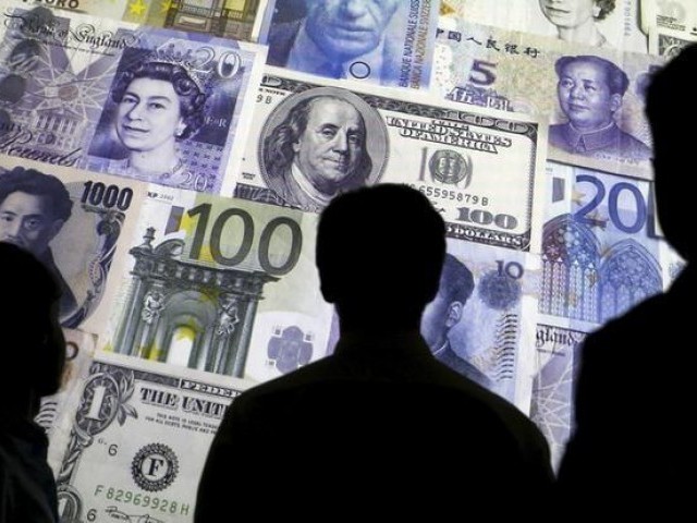 People are silhouetted against a backdrop projected with the picture of various currencies of money in this illustration taken April 4, 2016. PHOTO: REUTERS