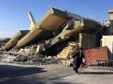 a-man-walks-past-a-damaged-building-following-an-earthquake-in-darbandikhan
