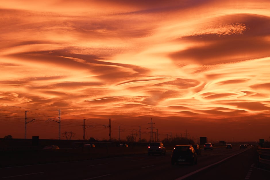 Cars drive at sunset on the highway Milan-Turin near Novara, northwest Italy. PHOTO: AFP