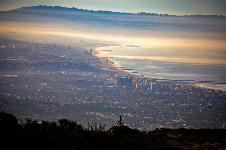 A mountain biker overlooks the bay and the Pacific Ocean from the Santa Monica mountains at sunrise in Los Angeles, California, US. PHOTO: REUTERS