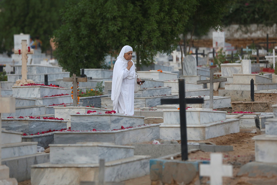 A Christian woman walks while searching for a grave of relative at a cemetery during the observance of All Souls Day in Karachi, Pakistan. PHOTO: REUTERS