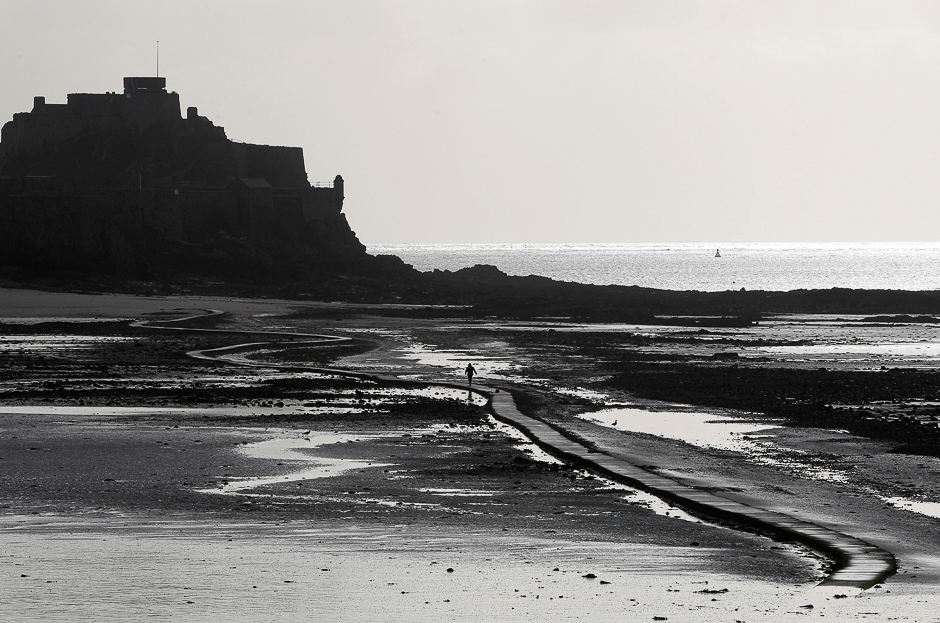 A man walks out on the tidal causeway to Elizabeth Castle in St Helier, Jersey, Britain. PHOTO: REUTERS