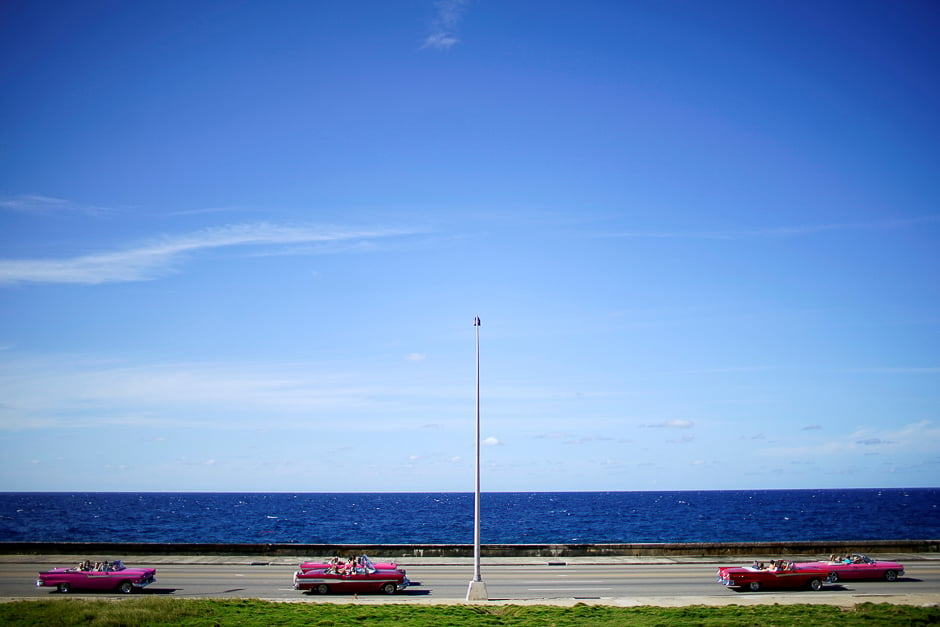 Tourists ride in vintage cars at the seafront Malecon in Havana, Cuba. PHOTO: REUTERS