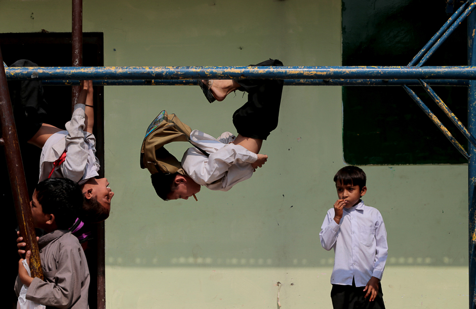 Children play on the monkey bars at the Mashal Model school in Islamabad, Pakistan. PHOTO: REUTERS