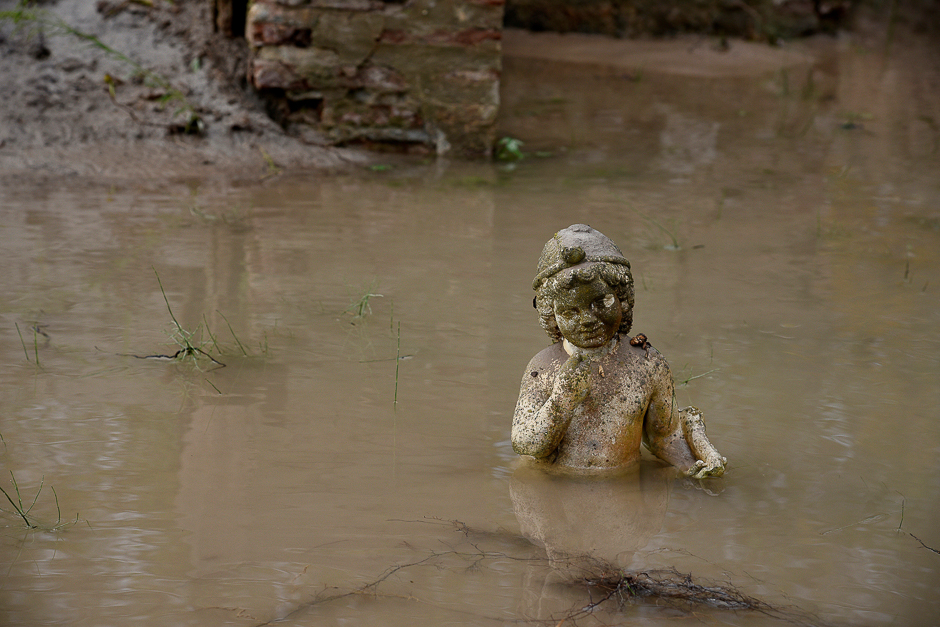 An ancient statue is partly submerged under water at an archaeological site, following flash floods which hit the area, at the village of Dion, Greece. PHOTO: REUTERS