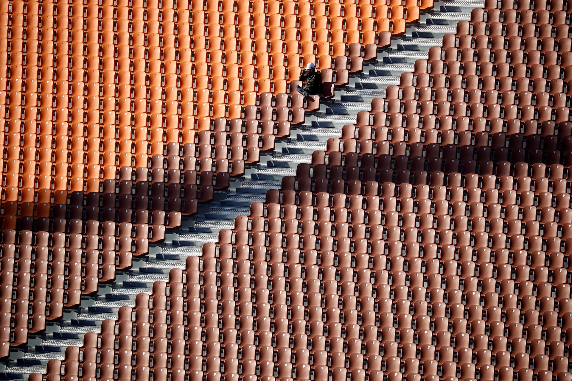 A worker rests on a seat at the Olympic Plaza, the venue for the opening ceremony of the 2018 Winter Olympic Games, Pyeongchang, South Korea. PHOTO: REUTERS