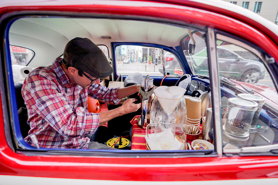 Matthew Pendleton uses brewing equipment in his 1968 VW Bug converted into a coffee cart in downtown Denver, Colorado US. PHOTO: REUTERS