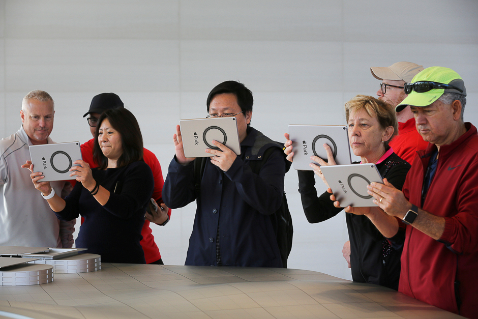 Visitors use iPads with augmented reality apps on them to discover features of the new Apple Park at the Apple Visitor Center in Cupertino, California. PHOTO: REUTERS
